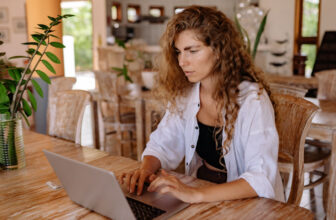 woman in front of her laptop making money with bitcoin
