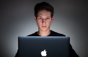 young man learning how to set up a bitcoin wallet on his mac
