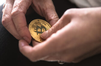 person holding a physical bitcoin and wondring what is the best way to store crypto